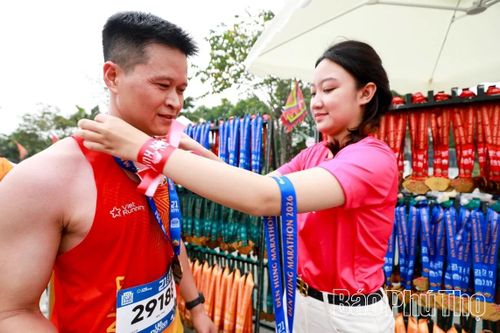 Thành viên Ban Tổ chức trao huy chương cho các vận động viên hoàn thành cự ly đăng ký.