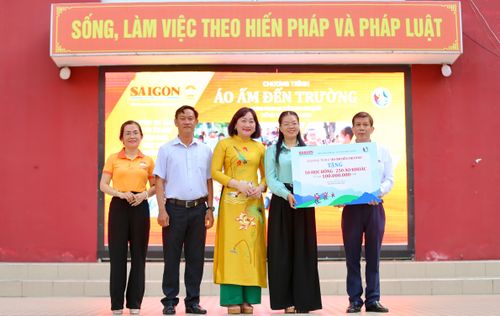 Quyền Tổng biên tập báo Sài Gòn Giải Phóng trao bảng cho đại diện Ủy ban Mặt trận Tổ quốc Việt Nam xã Bình Lợi. Ảnh: DŨNG PHƯƠNG