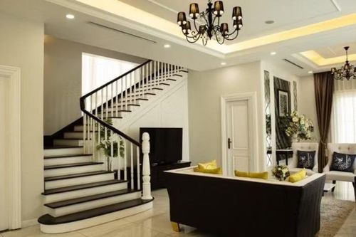 Cầu thang có màu trắng đen, phù hợp với phong cách thiết kế chung của căn nhà. Ở tầng 2 cũng có 1 không gian phòng khách khác, nhỏ hơn nhưng vẫn khá tiện nghi. Chủ nhà đặt 3 tủ lớn màu trắng trong không gian này để trưng bày một số đồ dùng