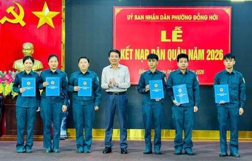 Đại diện lãnh đạo phường Đồng Hới trao quyết định kết nạp công dân tham gia thực hiện nghĩa vụ dân quân tự vệ năm 2026 - Ảnh: H.Tr