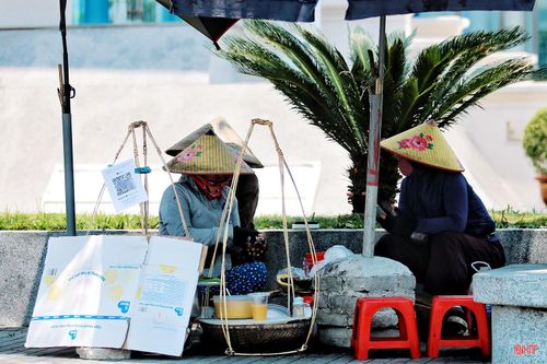 Ngồi bên vỉa hè, người dân có thể cảm nhận rõ cái nắng “rát da” hắt lên hầm hập từ mặt đường, khiến không gian trở nên oi nồng, bức bối hơn.