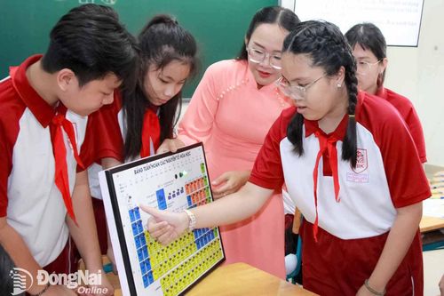 Học sinh Trường THCS Nguyễn Bỉnh Khiêm (phường Trấn Biên) được trải nghiệm sản phẩm sáng tạo Bảng tuần hoàn các nguyên tố hóa học điện tử. Ảnh: Nga Sơn