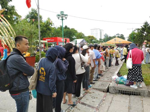 Người dân 'đội nắng' xếp hàng chờ nhận bánh mì tại các gian hàng tại Lễ hội Bánh mì Việt Nam.