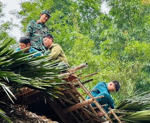 Các lực lượng tham gia lợp lại mái nhà cho gia đình ông Hoàng Văn Xiêm.