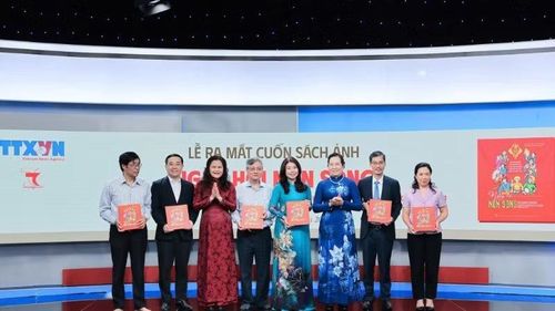 Phó Tổng Giám đốc Thông tấn xã Việt Nam Nguyễn Thị Sự tặng sách ảnh "Ngày hội non sông" cho các đại biểu.