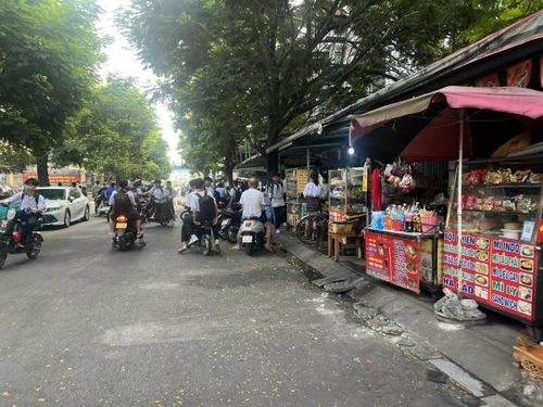 Nhiều thực phẩm an nhanh như mì, bánh, xiên chiên bày bán khu vực cổng sau Trường THCS Nguyễn Trãi.