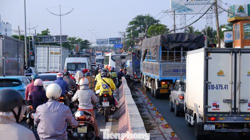 Lưu lượng phương tiện gia tăng khiến khu vực cầu vượt nút giao Bình Thuận đến điểm giao giữa đường Lê Khả Phiêu - Nguyễn Hữu Trí - Hoàng Đạo Thúy đông đúc, xe xếp hàng để di chuyển.