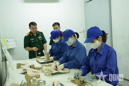  Đại tá Nguyễn Đức Thiện, Chủ nhiệm Kho KV1, Cục Quân khí kiểm tra nhân viên bao gói đạn tại Kho KV1. Ảnh: THÁI KIÊN 