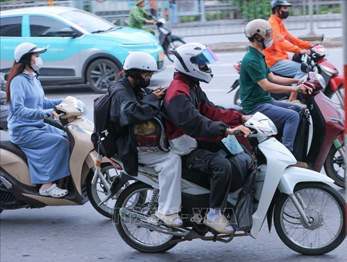 Người dân với hành lý, đồ đạc được chằng buộc cẩn thận hướng từ Quốc lộ 1A đi vào TP Hà Nội.