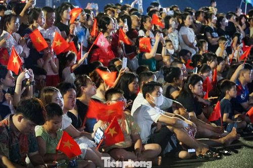 Dù phải chờ đợi hàng giờ đồng hồ, các bạn trẻ vẫn kiên nhẫn xếp hàng và vẫy cờ cổ vũ nhiệt tình khi các khối diễu hành đi ngang qua.