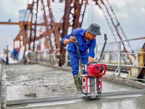 Công nhân duy trì thi công 3 ca liên tục trên mặt cầu Long Biên nhằm bảo đảm tiến độ thông cầu vào ngày 27/5/2026. Ảnh: Trung Nguyên - TTXVN