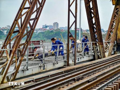 Các mũi thi công được chia nhỏ dọc mặt cầu Long Biên do điều kiện mặt bằng chật hẹp, phương tiện cơ giới lớn không thể tiếp cận. (Ảnh: Trung Nguyên/TTXVN)