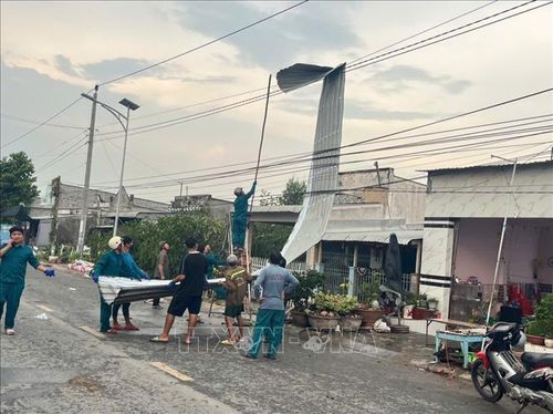 Lực lượng chức năng hỗ trợ người dân khắc phục hậu quả do trận dông lốc gây ra ở xã Long Phú Thuận (tỉnh Đồng Tháp). Ảnh: TTXVN phát