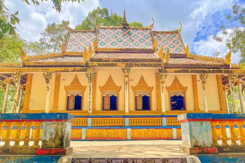  Khu vực cửa sổ bên hông chùa Dơi thường được các chư tăng ngồi đọc sách. Phía trên các cột là tượng đắp nổi mô tả cảnh tiên nữ Khmer chắp tay hành lễ. Ảnh: Henry Dương. 