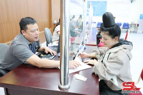 Công chức Trung tâm phục vụ hành chính công phường Chiềng Cơi hướng dẫn người dân xác thực thông tin.