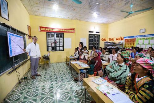 Trong căn phòng học nhỏ tại điểm trường bản Làng Sáng, 29 học viên là phụ nữ dân tộc Mông trong bản đang chăm chú nghe thầy dạy chữ. Ảnh: Trọng Đạt-TTXVN