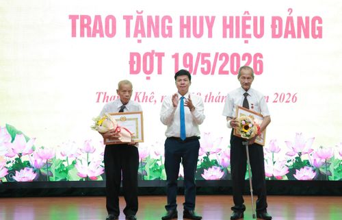 Trưởng ban Nội chính Thành ủy Võ Công Chánh trao Huy hiệu 65 năm tuổi Đảng và tặng hoa chúc mừng các đảng viên. Ảnh: ĐẮC MẠNH