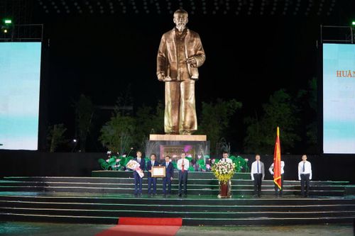 Đồng chí Đoàn Minh Huấn, Ủy viên Bộ Chính trị, Giám đốc Học viện Chính trị Quốc gia Hồ Chí Minh trao Huân chương Lao động hạng Nhất cho Khu di tích Kim Liên, đồng thời trao Bằng chứng nhận và tặng hoa cho tập thể lãnh đạo Khu di tích Kim Liên. Ảnh: QT