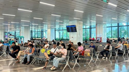 Người dân ngồi chờ lên máy bay tại sân bay Tân Sơn Nhất.