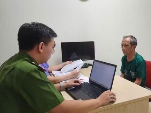 Cảnh sát làm việc với ông Nguyễn Tiến Nam. Ảnh: Tiền Phong.