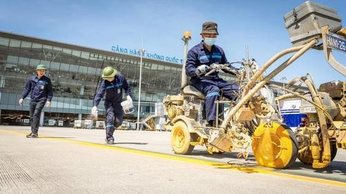  Công nhân thực hiện công tác sơn kẻ tín hiệu, vị trí đỗ máy bay, đảm bảo đúng tiêu chuẩn an toàn bay dưới thời tiết nắng như đổ lửa. 