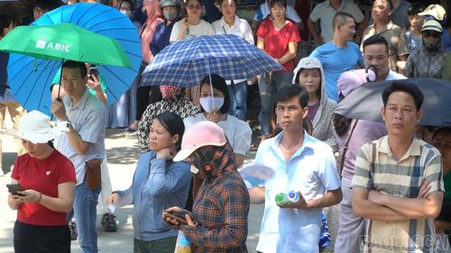 Trên gương mặt nhiều phụ huynh hiện rõ sự mệt mỏi do thời tiết nắng nóng, song nổi bật hơn cả vẫn là ánh mắt dõi theo đầy lo lắng và kỳ vọng, hướng về phía cổng trường khép kín.