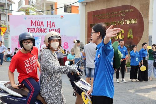 Lực lượng đoàn viên, thanh niên hướng dẫn các thí sinh và phụ huynh đến làm thủ tục dự thi. Ảnh: ĐH
