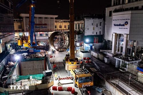Cấu kiện TBM được cẩu qua miệng ga ngầm S12 trước khi đưa lên xe chuyên dụng vận chuyển ra khỏi công trường. (Ảnh: Trung Nguyên/TTXVN)