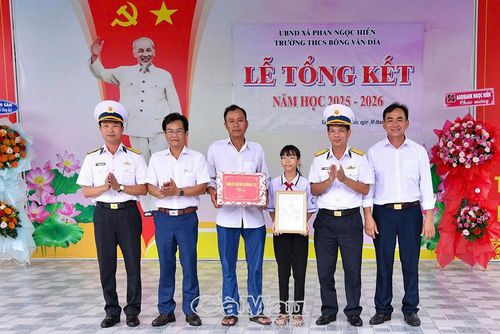 Đại tá Bùi Quang Phẩm, Chính ủy Lữ đoàn 175 (thứ hai từ phải sang), trao quyết định nhận đỡ đầu em Hồng Cát Tường.