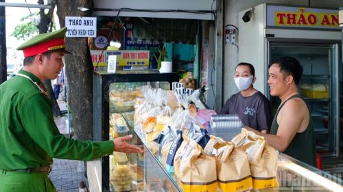 Công an phường Vũng Tàu nhắc nhở người dân thực hiện nghiêm quy định về trật tự lòng, lề đường. (Ảnh: THẾ ANH)