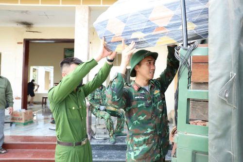 Cán bộ Công an giúp người dân vận chuyển đồ đạc.