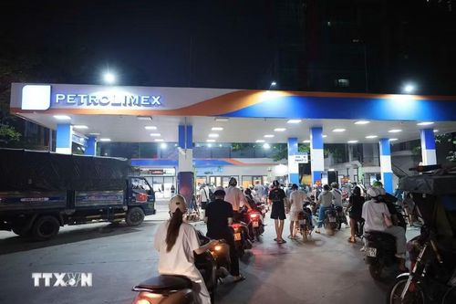 Khách hàng mua xăng tại cây xăng trên phố Nam Đồng (đêm 31/5). (Ảnh: Phạm Tuấn Anh/TTXVN)