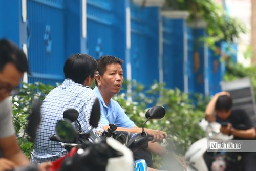 Từ khoảng 6h sáng, khu vực trước cổng Trường THCS Lê Lợi và Trường THCS Quang Trung đã đông kín phụ huynh đưa con đi thi. Nhiều người đứng nép dưới tán cây, liên tục nhìn đồng hồ chờ con hoàn thành môn Ngữ văn đầu tiên. (Ảnh: Mỹ Hậu)