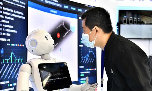 Người tham dự tương tác với một robot tại một hội nghị thượng đỉnh về trí tuệ nhân tạo ở Trung Quốc, ngày 19/4/2021. Ảnh: Xinhua