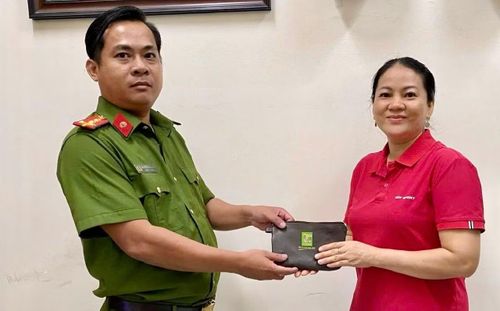Niềm vui của chị Tuyết khi nhận lại tài sản từ tay cán bộ chiến sĩ Công an xã Nhà Bè.