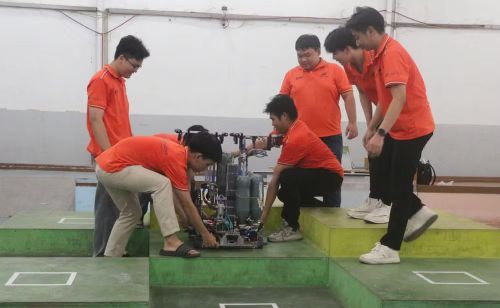 Các thành viên đội LF-FOF, Trường đại học Lạc Hồng, thành phố Đồng Nai đang tiếp tục cải tiến robot chuẩn bị tham dự cuộc thi ABU Robocon châu Á-Thái Bình Dương. (Ảnh: Lê Xuân/TTXVN)