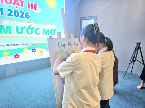 Các em học sinh tham gia hoạt động viết ước mơ lên những chiếc lá nhỏ và gắn lên “cây ước mơ”.