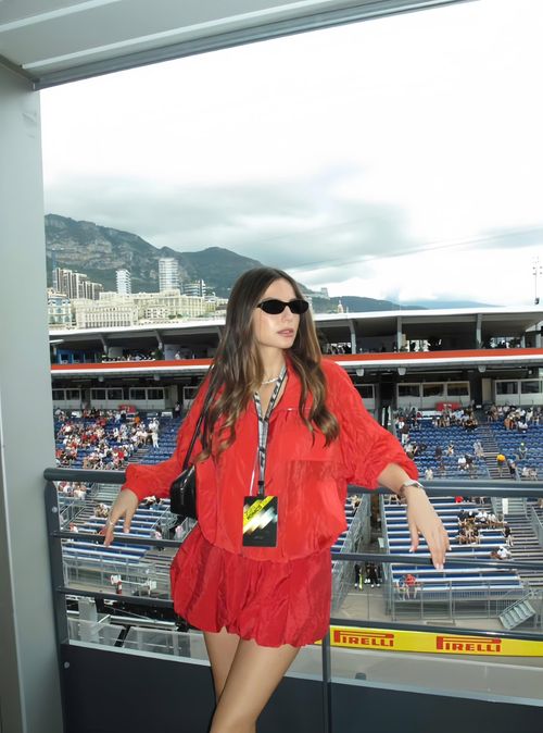 Kelly Piquet, bạn gái Max Verstappen, cũng thu hút sự chú ý với set đồ đỏ tươi đồng bộ với chất liệu nhăn nhẹ, phần chân váy bí tạo độ phồng mềm mại. Cô nàng cũng kết hợp sử dụng kính mát gọng nhỏ, túi xách đen và trang sức tối giản để hoàn thiện bộ trang phục. Kelly hiện là người mẫu, influencer với hơn 2,3 triệu người theo dõi trên Instagram, đồng thời đã có con chung với Verstappen vào tháng 5/2025. Ảnh: @kellypiquet/IG.