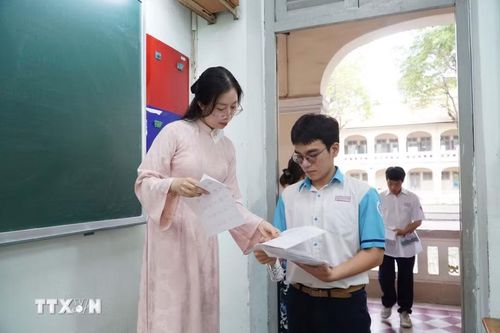 Cán bộ coi thi kiểm tra thông tin thí sinh trước khi vào phòng thi tại điểm thi Trường Trung học phổ thông chuyên Lê Hồng Phong. (Ảnh: Thu Hoài/TTXVN)