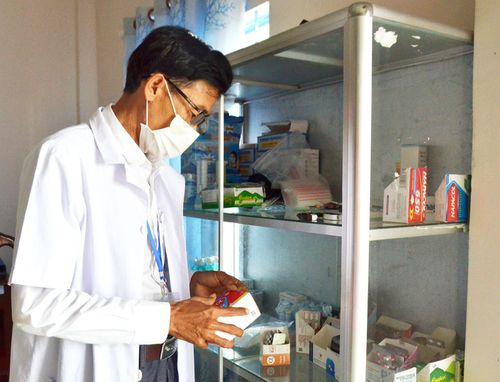 Bác sĩ Nguyễn Hoàng Tuyên, nhân viên Trạm Y tế xã Hòn Đất, trực tại điểm thi Trường THPT Hòn Đất kiểm tra cơ số thuốc phục vụ kỳ thi. Ảnh: MI NI