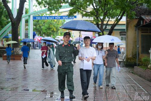 Các đội hình tình nguyện che ô, đưa thí sinh vào tận phòng thi.