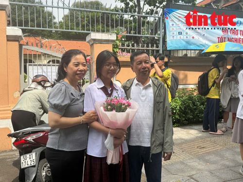 Thí sinh Ánh Hoa, học sinh Trường THPT Thực hành Sư phạm, TP Hồ Chí Minh được cha mẹ tặng bó hoa sau khi kết thúc kỳ thi.