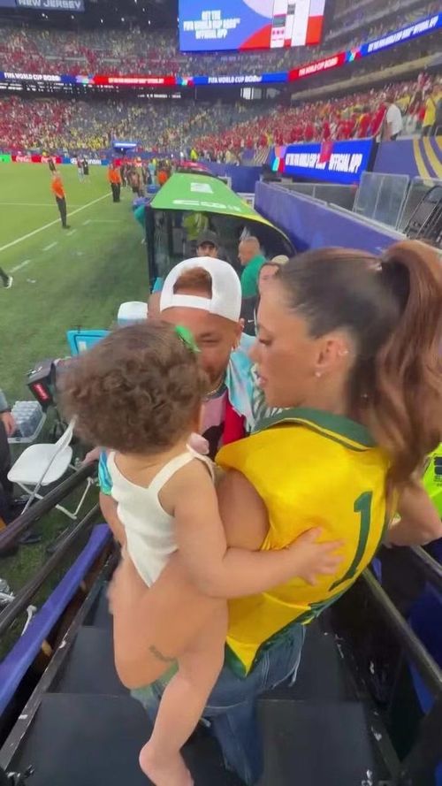 Siêu mẫu Bruna Biancardi bế con gái khi gặp Neymar sát khu kỹ thuật. Hình ảnh gia đình của tiền đạo Brazil tạo nên điểm nhấn mềm mại giữa bầu không khí nóng bỏng của World Cup
