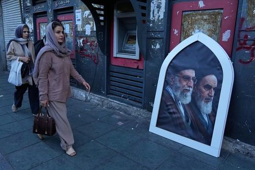 Người dân đi lại tại thủ đô Tehran - Iran hôm 14-6. Ảnh: AP