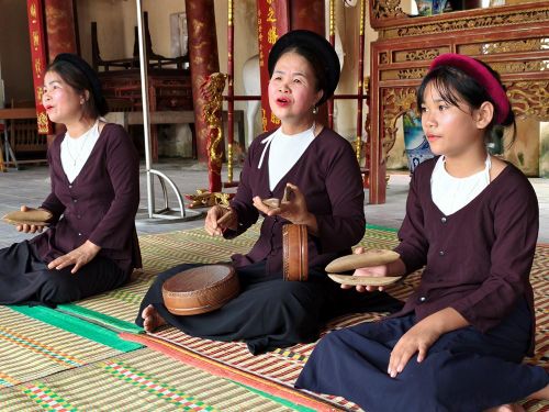 Cô Phạm Thị Kim Ngân (giữa) đang dạy hát Xẩm cho các em học sinh tại Di tích lịch sử đình làng Nộn Khê
