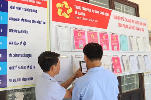Cán bộ hướng dẫn người dân thực hiện thủ tục tại Trung tâm Phục vụ hành chính công xã Hà Nha. Ảnh: TRẦN TRÚC