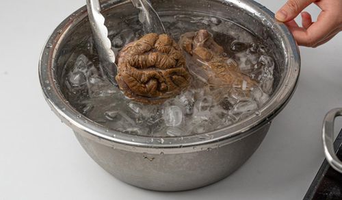 Sau khi thịt chín, vớt ngay ra tô nước đá lạnh để thịt săn chắc và tạo độ giòn (Ảnh: Gofood)