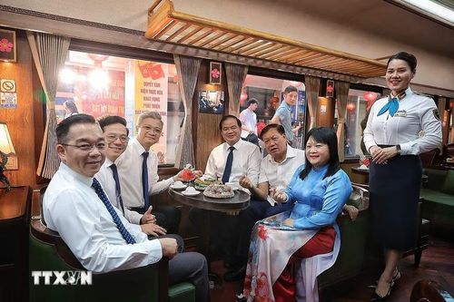 Các đại biểu lưu lại kỷ niệm trên chuyến tàu. (Ảnh: Phạm Tuấn Anh/TTXVN)