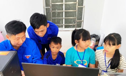 Các tình nguyện viên hướng dẫn học sinh sử dụng máy tính.