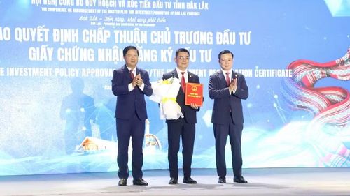  Bí thư Tỉnh ủy Lương Nguyễn Minh Triết (bên trái), Chủ tịch UBND tỉnh Đỗ Hữu Huy (bên phải) trao quyết định, tặng hoa cho nhà đầu tư tại Hội nghị. (Ảnh: TT) 